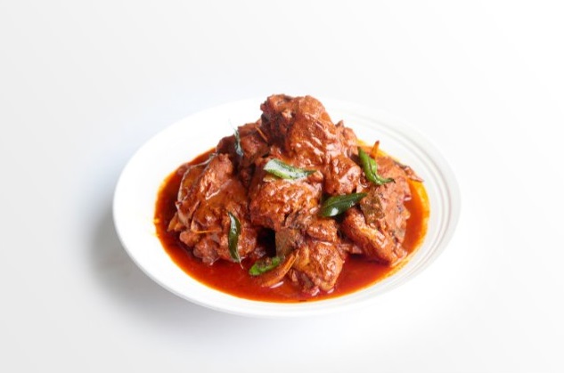 A steaming hot bowl of aromatic and flavorful chicken curry, garnished with fresh cilantro leaves, ready to be enjoyed with a side of rice or bread